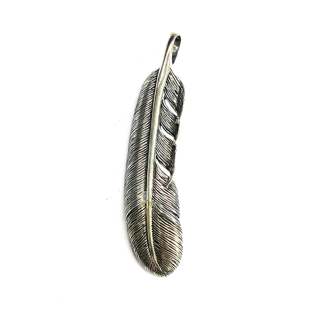Silver feather pendant with little brass plating
