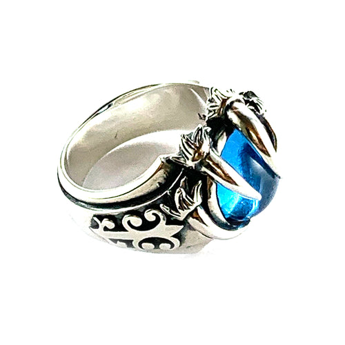 Three claw silver ring with light blue stone