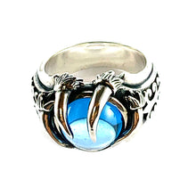 Three claw silver ring with light blue stone